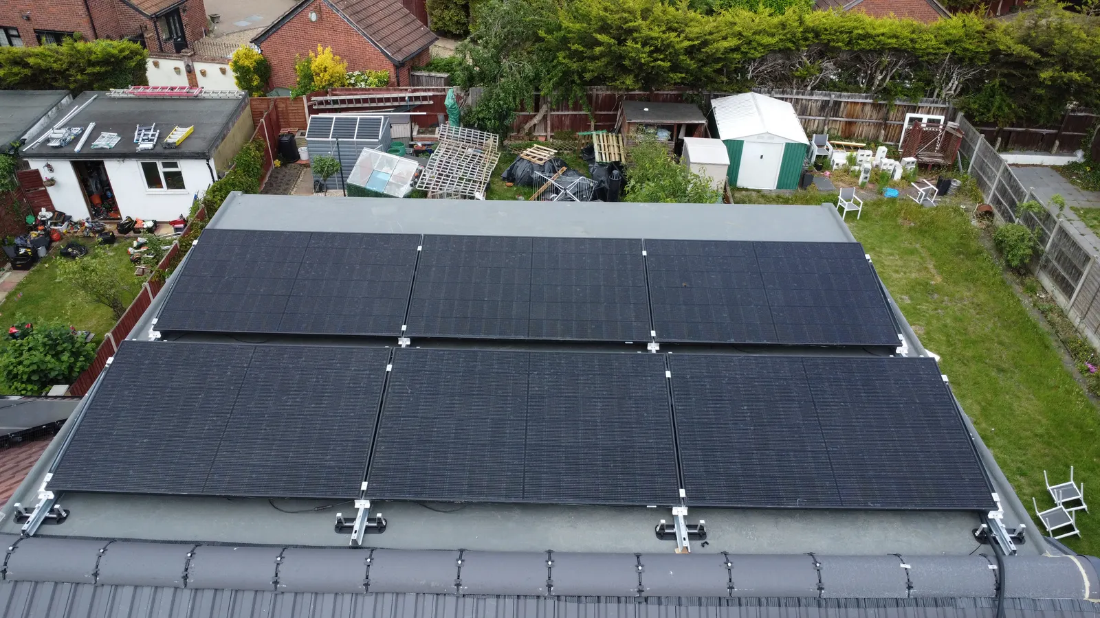 Solar panels on tilt frames on a flat roof in Chadwell Heath